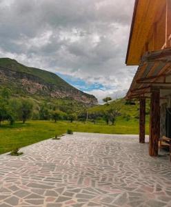 a stone patio with a view of a mountain at Vardzia Hills in Gogasheni
