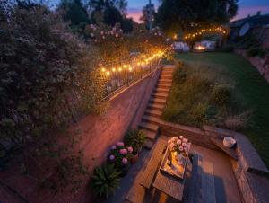 an overhead view of a garden with a bench and lights at Living light in Dallington