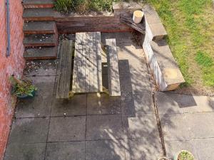 an overhead view of a patio with a wooden bench at Living light in Dallington