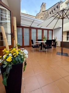 a patio with a table and chairs and an umbrella at Laros Pios Alojamiento 4 in Villalba
