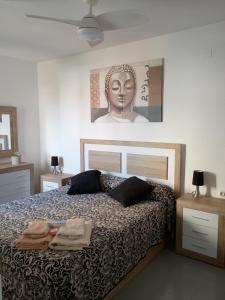 a bedroom with a bed with a statue of a head at Elisenda in Vinarós