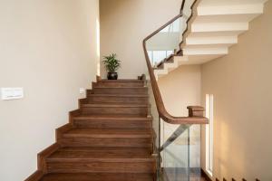 a staircase with a glass railing and wooden floors at Hotel Mounten View Near PEC & PGI in Chandīgarh