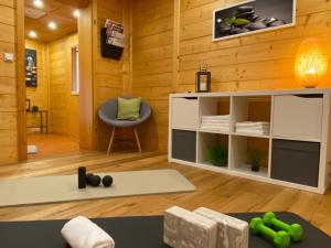 a room with wood paneling and a room with a table and a chair at MEB Appartement, luxuriöses Appartement, im Chalet-Stil nur für Zwei, mit privater Sauna im Oberallgäu in Blaichach