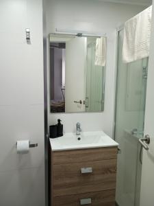 a bathroom with a sink and a shower with a mirror at Elisenda in Vinarós +20 photos