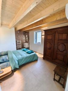 a bedroom with a large bed and a wooden ceiling at Gîte de la Vonne in Vimines