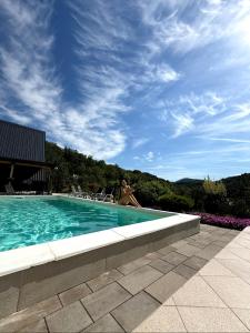 a woman is sitting in a swimming pool at Panorama Pool Hills in Ledinci