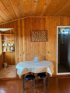 a dining room with a table in a wooden room at Silk Way in Ureki +13 photos
