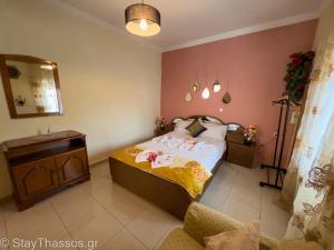 a bedroom with a bed and a table and a mirror at Apartment Lampiri in Limenaria