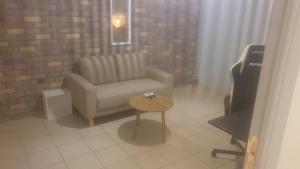 a living room with a couch and a table at O&M Port Piraeus in Piraeus