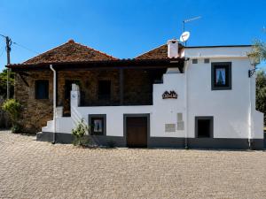 a white building with a brown roof at Casa dos Laia in Sobreira Formosa