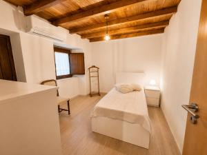 a bedroom with a bed in a room with wooden ceilings at Casa dos Laia in Sobreira Formosa