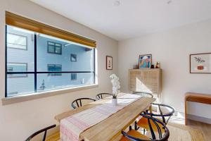 a dining room with a table and chairs and a window at Skywalk Flats Escape in Silverthorne