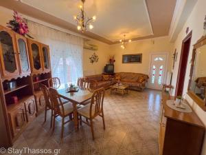 a living room with a table and a couch at Apartment Lampiri in Limenaria