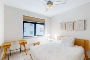 a bedroom with a bed and a desk and a window at Skywalk Flats Escape in Silverthorne +80 photos