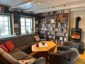 a living room with a couch and a fireplace at Kulturgården Bjerkem in Steinkjer