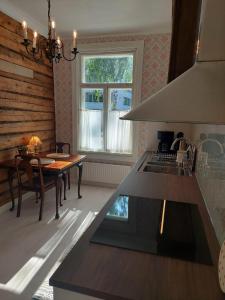 a kitchen with a sink and a table and a window at Villa Matilda in Uusikaupunki +30 photos