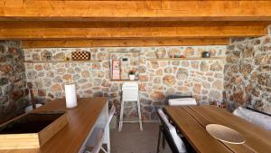 a kitchen with stone walls and a table at House RudNik in Silent Village, Island Krk in Isola Veglia