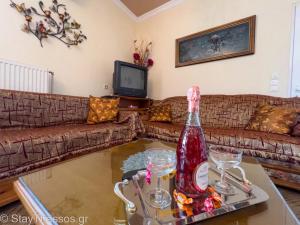 a living room with a bottle of wine on a table at Apartment Lampiri in Limenaria