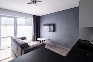 a living room with a couch and a table at Apartmány Michelle in Dolní Dunajovice