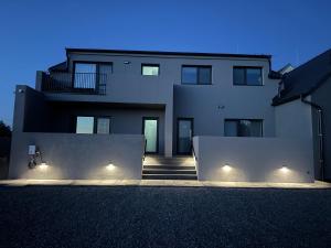 a large white building with lights in front of it at Apartmány Michelle in Dolní Dunajovice