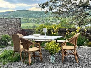 a table and two chairs and a table with a view at Dusheti Retreat - Authentic Georgian Living in Dushetʼi