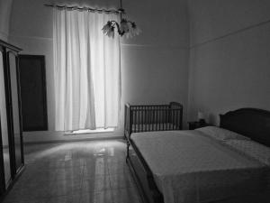 a bedroom with a bed and a large window at Frangio' in Noci