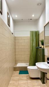 a bathroom with a tub and a toilet and a sink at Beautiful Rooms - Park Kasprowicza in Szczecin