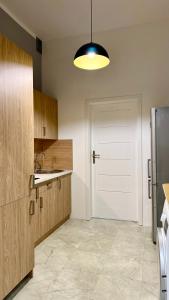 a kitchen with a sink and a white door at Beautiful Rooms - Park Kasprowicza in Szczecin +14 photos
