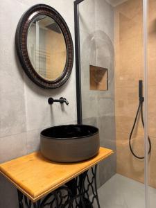 a bathroom with a black sink and a mirror at Atelier Volturno in La Maddalena