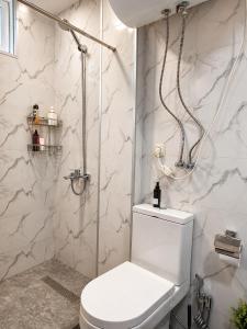 a white bathroom with a toilet and a shower at Trio Villas Retreat in Grigoleti +40 photos