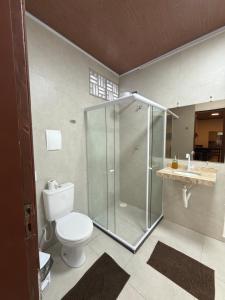 a bathroom with a shower and a toilet and a sink at Condomínio Feitosa Barros II in Maceió +69 photos