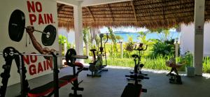 a gym with a bunch of exercise bikes in a room at Long Beach Resort, Nosy Be in Nosy Be