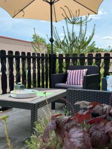 a patio with a table and chairs and an umbrella at Studio apartman Gradna in Samobor