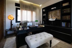 a living room with a white stool and a desk at Villa 4 chambres avec piscine in Tangier