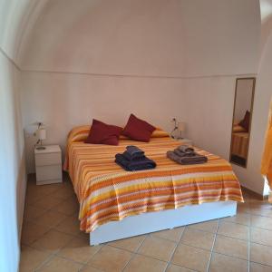 a bedroom with a bed with towels on it at Dammuso Surya Il cappero monolocale in Pantelleria