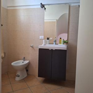 a bathroom with a sink and a toilet at Dammuso Surya Il cappero monolocale in Pantelleria