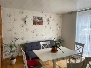 a dining room with a white table and chairs at Ferienwohnung Kannemann in Herzberg am Harz