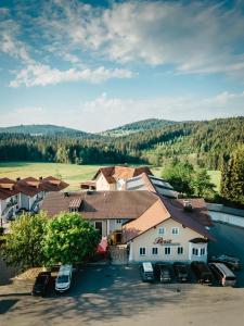 an aerial view of a house with cars parked in a parking lot at Hotel am Haidel in Hinterschmiding