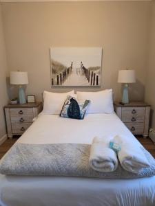 a bedroom with a bed and a painting of a pier at Shore Getaway 2 in Atlantic City +22 photos