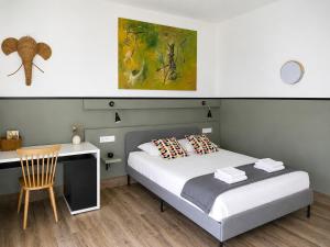 a bedroom with a bed and a desk with a chair at Casa Stay in Aix-en-Provence