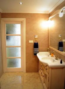 a bathroom with a sink and a mirror and a window at La Bolsa Apartment in Málaga