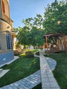 a garden with a stone walkway next to a house at Bilgah Garden Villa in Bilgah