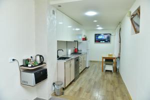 a kitchen with a sink and a stove top oven at Hayi Tun Guest House in Goris