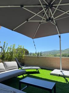 a patio with a table and an umbrella at La Terrazza di Luca B&B in Tavernelle