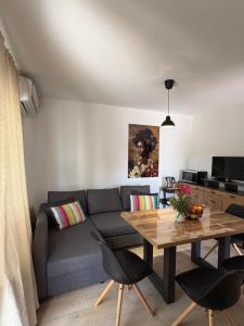 a living room with a couch and a table at Apartmani Primorski kutak in Jadranovo