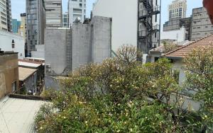 a view of a city with tall buildings and trees at The New Chapter Hostel in Ho Chi Minh City