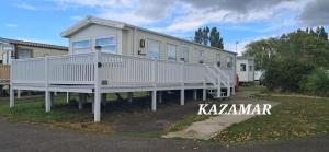 a large white house with a large porch at Kazamar in East Mersea