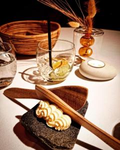 a table with wooden spoons and a plate of food at Kulturgården Bjerkem in Steinkjer