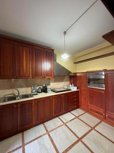 a kitchen with wooden cabinets and a sink at Da Francesca guestrooms in Patrica