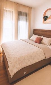 a large bed in a bedroom with a window at Apartment by Bar in Bar